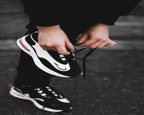 active mature man tying sport shoes